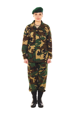 Young girl-soldier in the camouflage military uniform and a beret stands by the frontの写真素材
