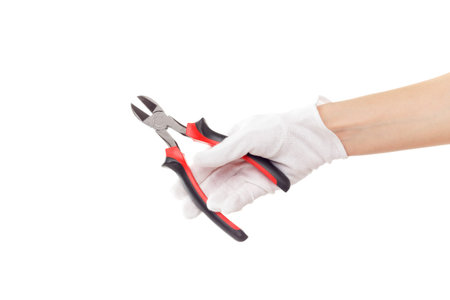 A red diagonal pliers in the hand, isolated