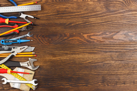 Set of different construction tools, wooden background