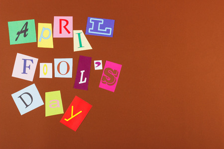April fool's day: collage from colorful paper letters, brown backgroundの写真素材