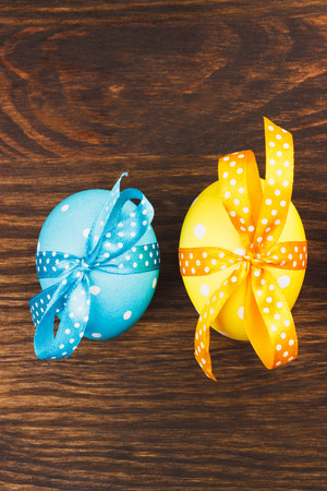 Colorful Easter eggs with decoration, wooden backgroundの写真素材