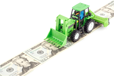 Children's plastic tractor toy with farmer inside, isolatedの写真素材