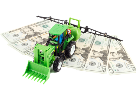 Children's plastic tractor toy with farmer inside, isolatedの写真素材