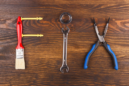 Word Fix from different construction tools, wooden background