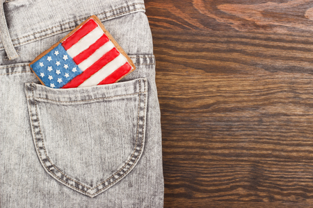 Rectangle shaped cookie with American patriotic colors in the pocket, wooden backgroundの写真素材