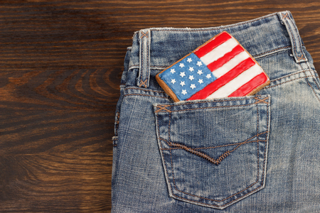 Flag shaped cookie with American patriotic colors in the denim's pocketの写真素材