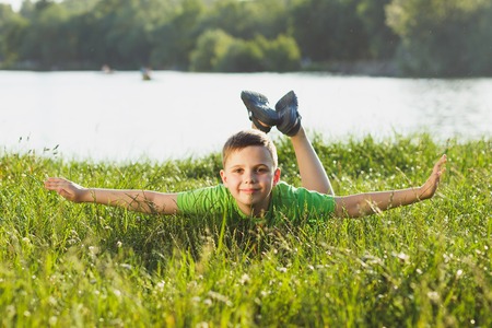 The boy plays game with virtual reality glasses outdoors. Digital vr deviceの写真素材