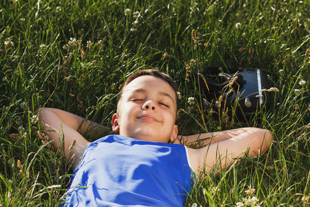 The boy plays game with virtual reality glasses outdoors. Digital vr deviceの写真素材