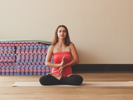 Woman makes yoga exercises, soft focus backgroundの写真素材
