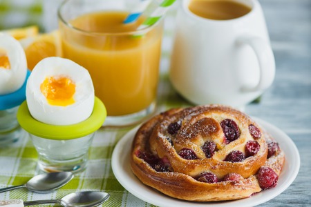Soft boiled chicken egg, baking and orange juice, soft focus backgroundの写真素材