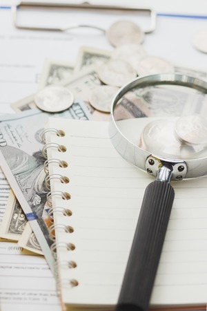 Clean insurance form, folders, magnifying glass and money, soft focus backgroundの写真素材
