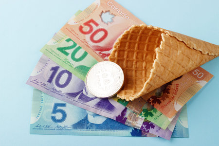 Currency: Canadian banknotes, coins and digital currency on the blue backgroundのeditorial素材