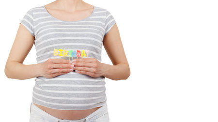 Pregnant woman with lettering of Happy Birthday in the hands, isolated