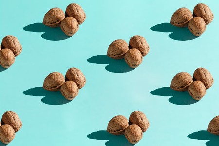 Background made from walnuts on the light blue backgroundの写真素材