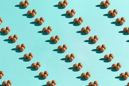 Background made from walnuts on the light blue backgroundの写真素材