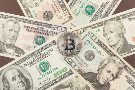 Background made from American dollars and bitcoin, dark base, top viewの写真素材