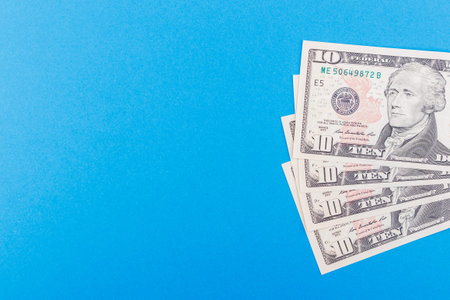 Different American dollars on the light blue base, top view
