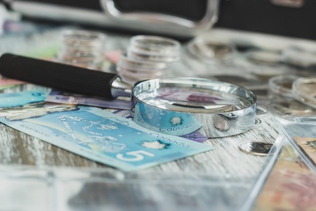 Canada: Hands in the white gloves hold different banknotes, top viewの写真素材