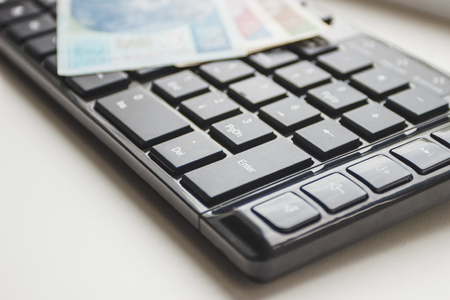 Concept: Different types of Polish money and keyboard, top viewの写真素材