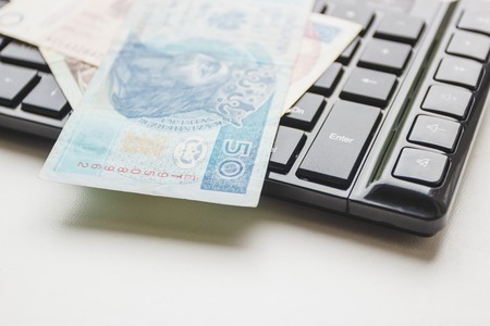 Concept: Different types of Polish money and keyboard, top viewの写真素材