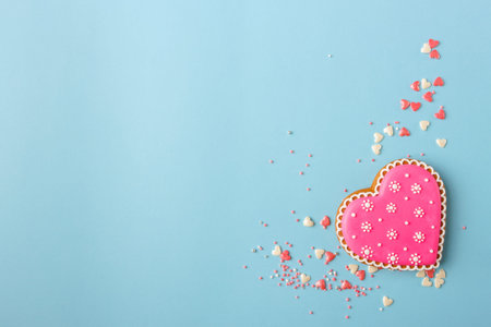Pink cookie heart shaped with different patterns on the light blue background