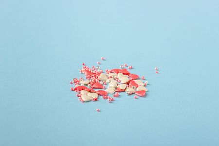 Pink cookie heart shaped with different patterns on the light blue backgroundの写真素材