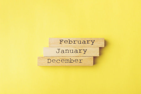 house shaped wooden logs on the yellow background, top view