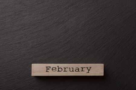 house shaped wooden logs on the black background, top viewの写真素材