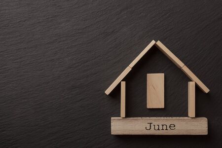 house shaped wooden logs on the black background, top viewの写真素材