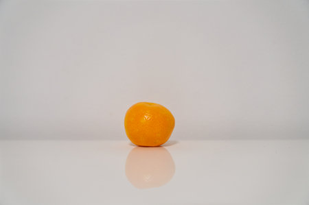 Ripe tangerine isolated on a white background with reflection.の写真素材