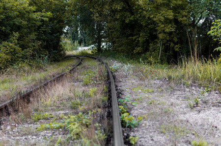 Old railway tracks and gravel leading into the infinite distance with selective focusの写真素材