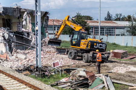 JCB excavator demolishes old building.