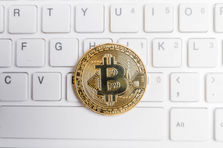 Bitcoin laying on a white computer keyboard