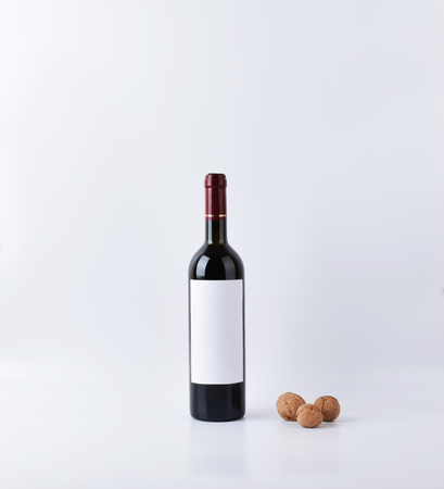 mockup wine bottle with three nuts, isolated on white background with copy space, front view.の写真素材