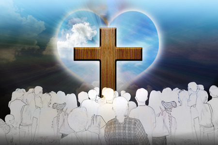 Crucifix and light with people on dark backgroundの写真素材