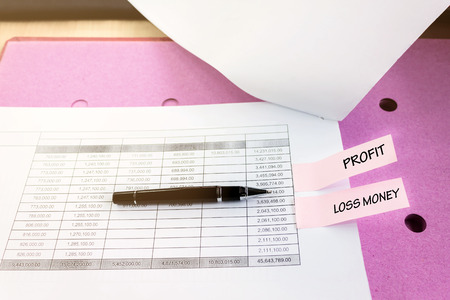 Financial document table with pen and text profit with loss money, business concept finance and copy spaceの写真素材
