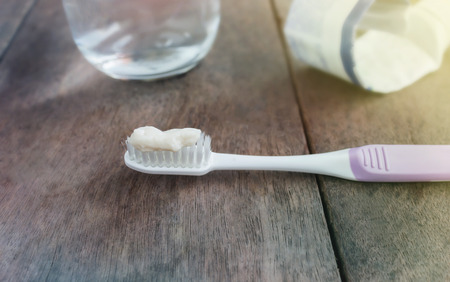 Toothbrush with toothpaste blurred background on wood table and copy spaceの写真素材