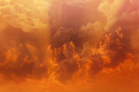 Beautiful dreamy colourful orange gold sky with puffy white clouds