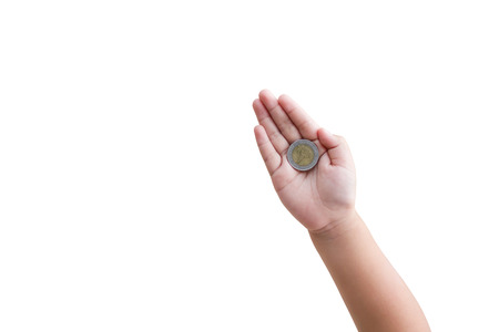 Isolated top view kid hand with coin on white backgroundの写真素材