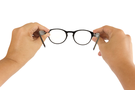 Hands take eyeglasses to wear on white backgroundの写真素材