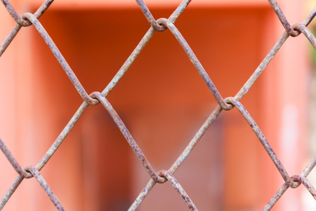 Rusty old balustrade or iron bar pattern on orange colour background, close-up rusty fenceの写真素材