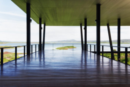 Blurred background wooden floor in airly or open balcony with reservoir or lake viewの写真素材