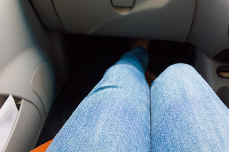 Wearing jeans sit in carの写真素材