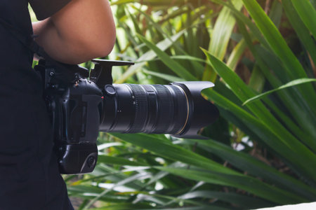 Close up camera with photographer backside, camera and camera man