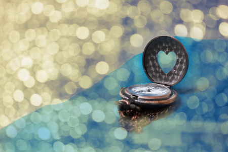 Romantic love bokeh background with heart shape clock for valentineの写真素材