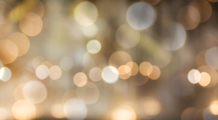 Romantic dreamy golden orange bokeh and white light backgroundの写真素材