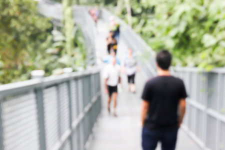 Blurred background people on long pathway sky walk in forest viewの写真素材