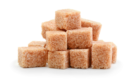 Brown cane sugar cubes isolated on whiteの写真素材