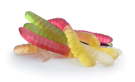 Heap of multi-colored candy worms isolated on white.