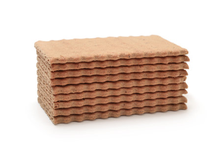 Stack of brown rye crispy bread isolated on white.